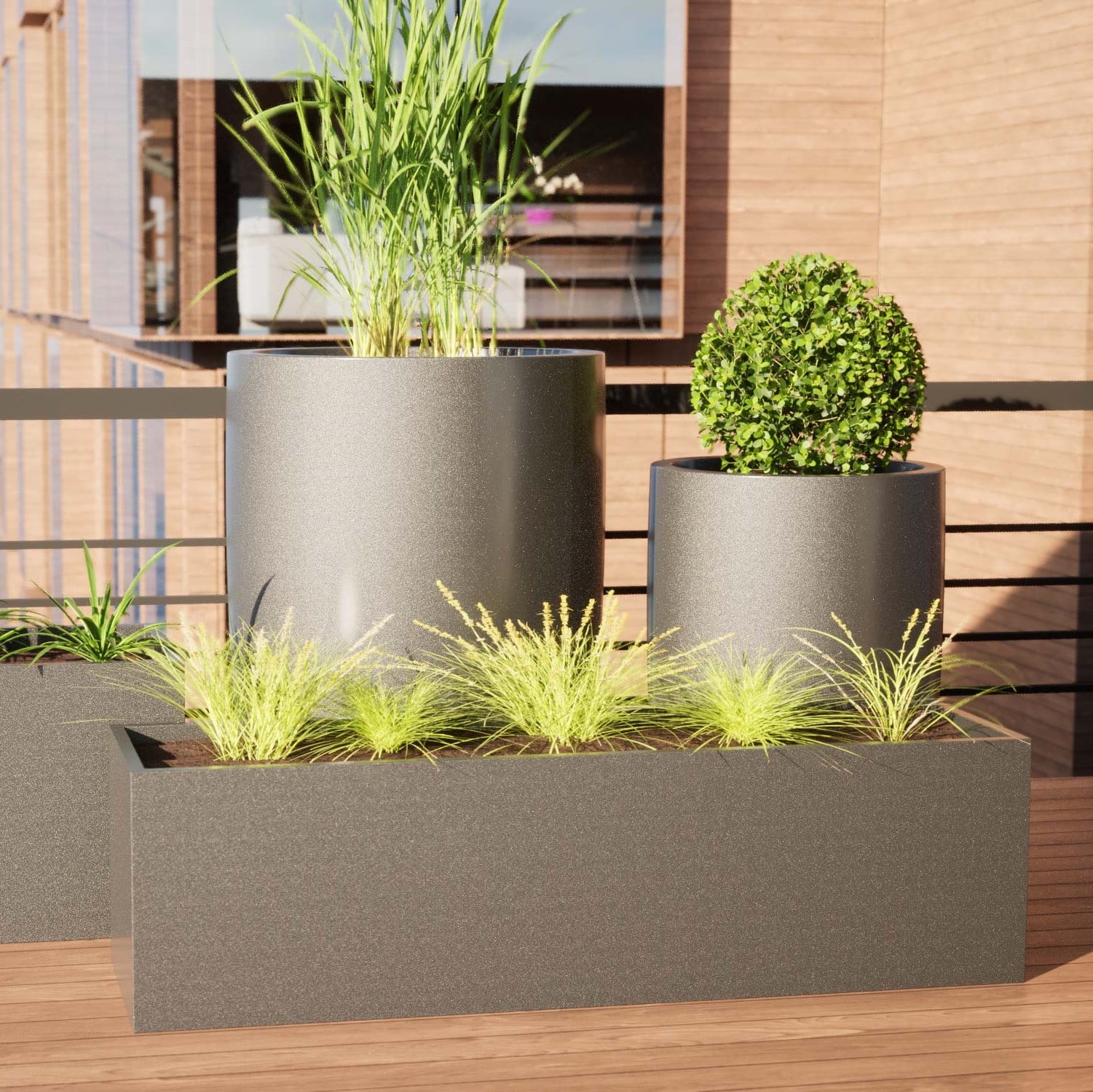 Verschiedene GFK Design Pflanzengefäße in Grau auf einer Terrasse